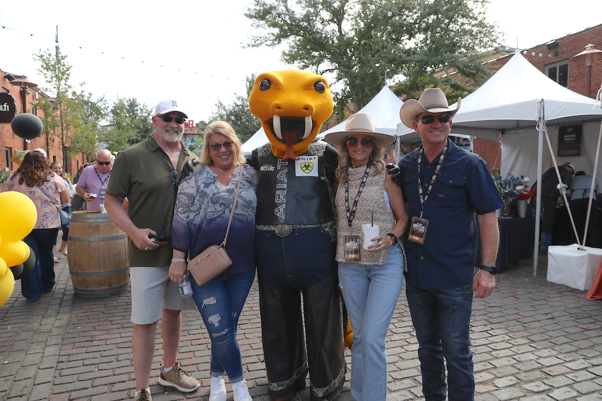 Rattle Battle attendees pose with the event's mascot at Mule Alley. | Photo by Bull Stock Media