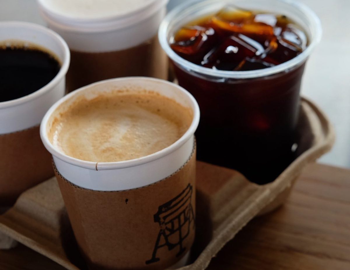 A loaded coffee carrier showcasing hot beverages at Giant Leap Coffee. | Photo by Giant Leap Coffee