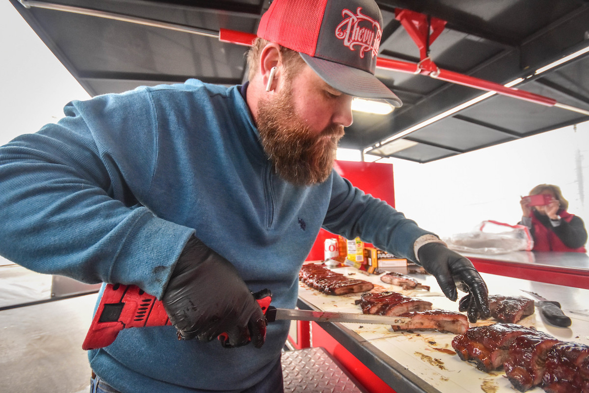Chevy Cookers slices up some ribs at the cook-off. | Photo by WCBBQ Committee Photographers 