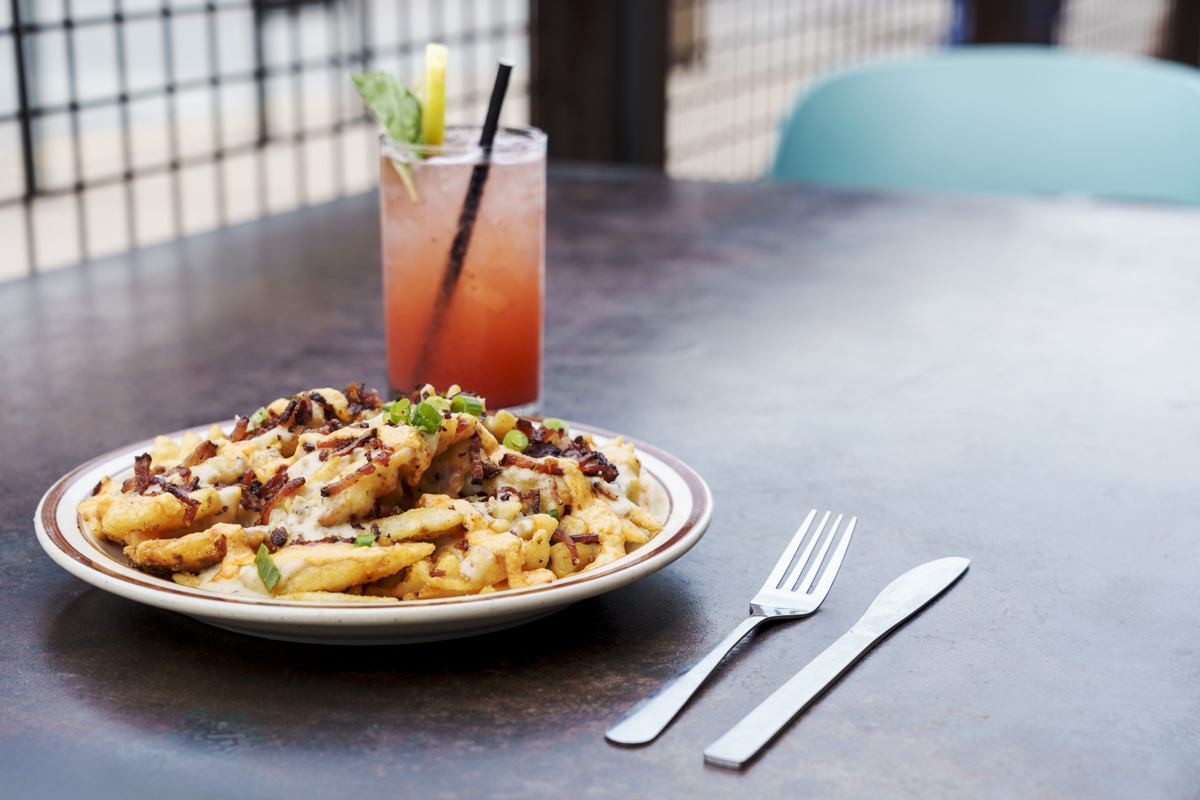 - DiningOut At happy hour, Atomic Cowboy sells its Sully's Fries for just $7. | Photo by Ashley Beguin