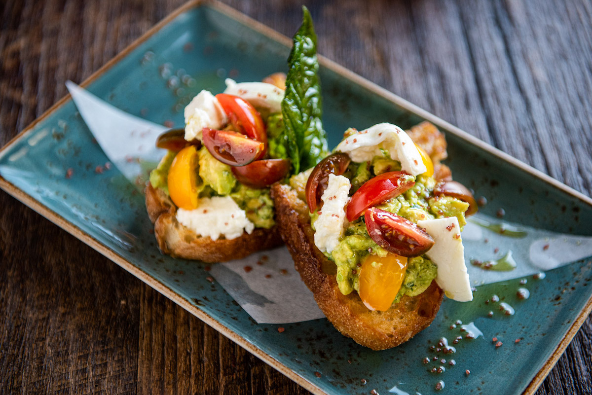 - DiningOut Global Avocado and burrata bruschetta at CRÚ Food & Wine Bar. | Photo by CRÚ Food & Wine Bar