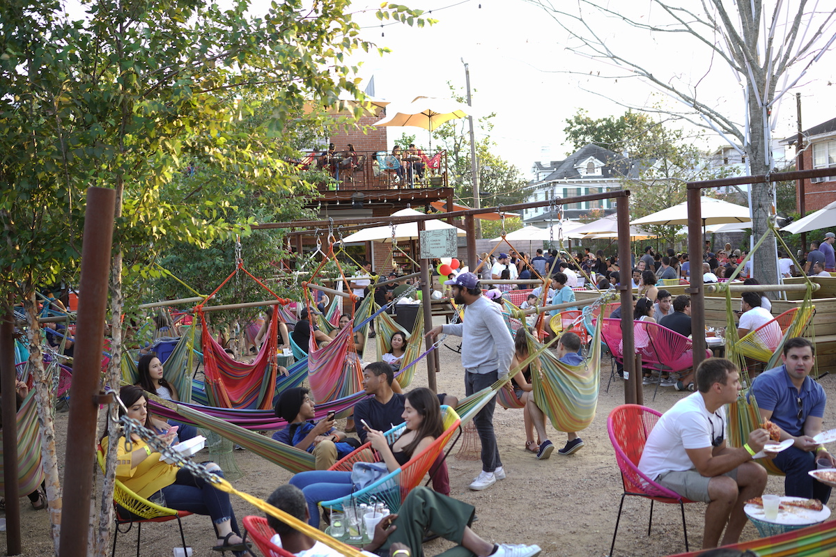 Guests lounge in the hammocks in the beer garden at Axelrad. | Photo by GOODSPERO