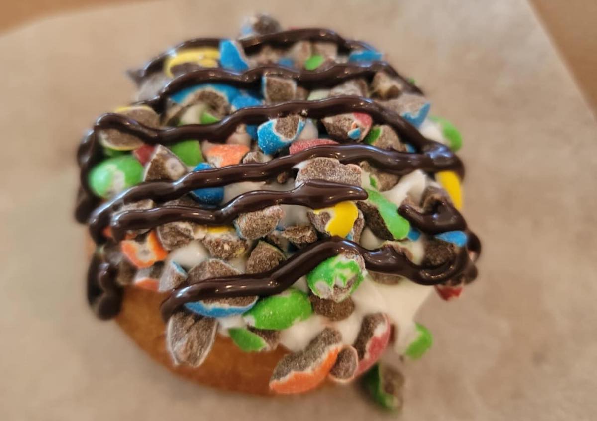 A doughnut topped with candy pieces at Batter and Beans. | Photo by Batter and Beans