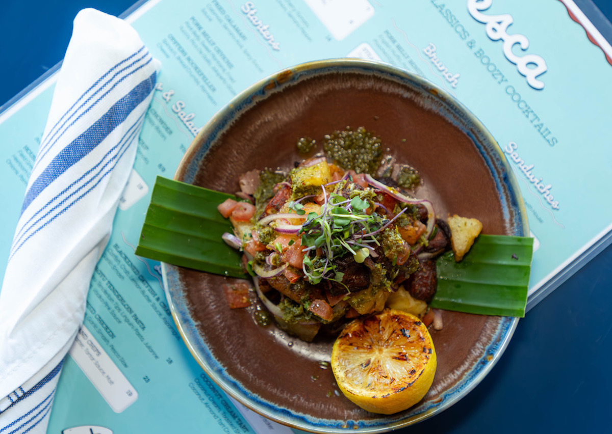 A seafood plate with potatoes and chimichurri at Pesca Coastal Classics and Boozy Cocktails. Photo by Pesca Coastal Classics and Boozy Cocktails