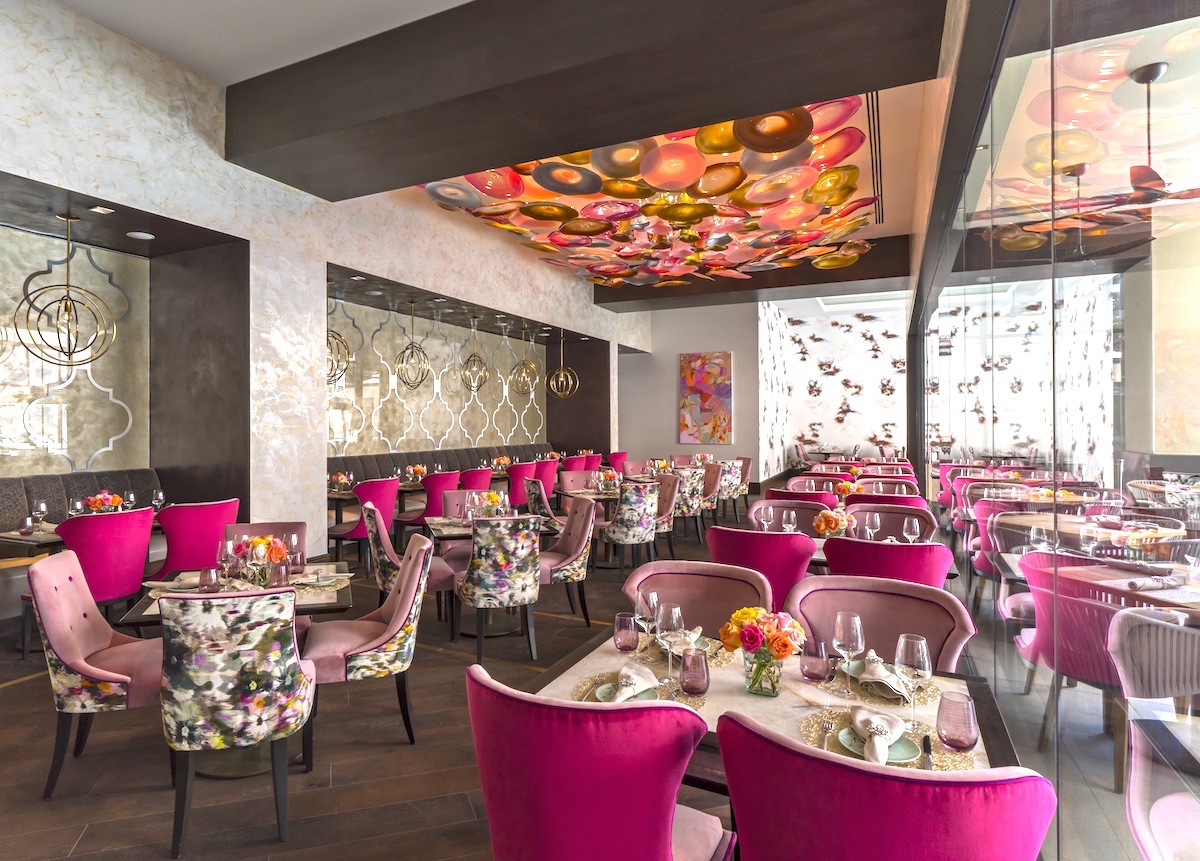 The well-appointed, pink-hued dining room at Bloom & Bee. | Photo by Landry's