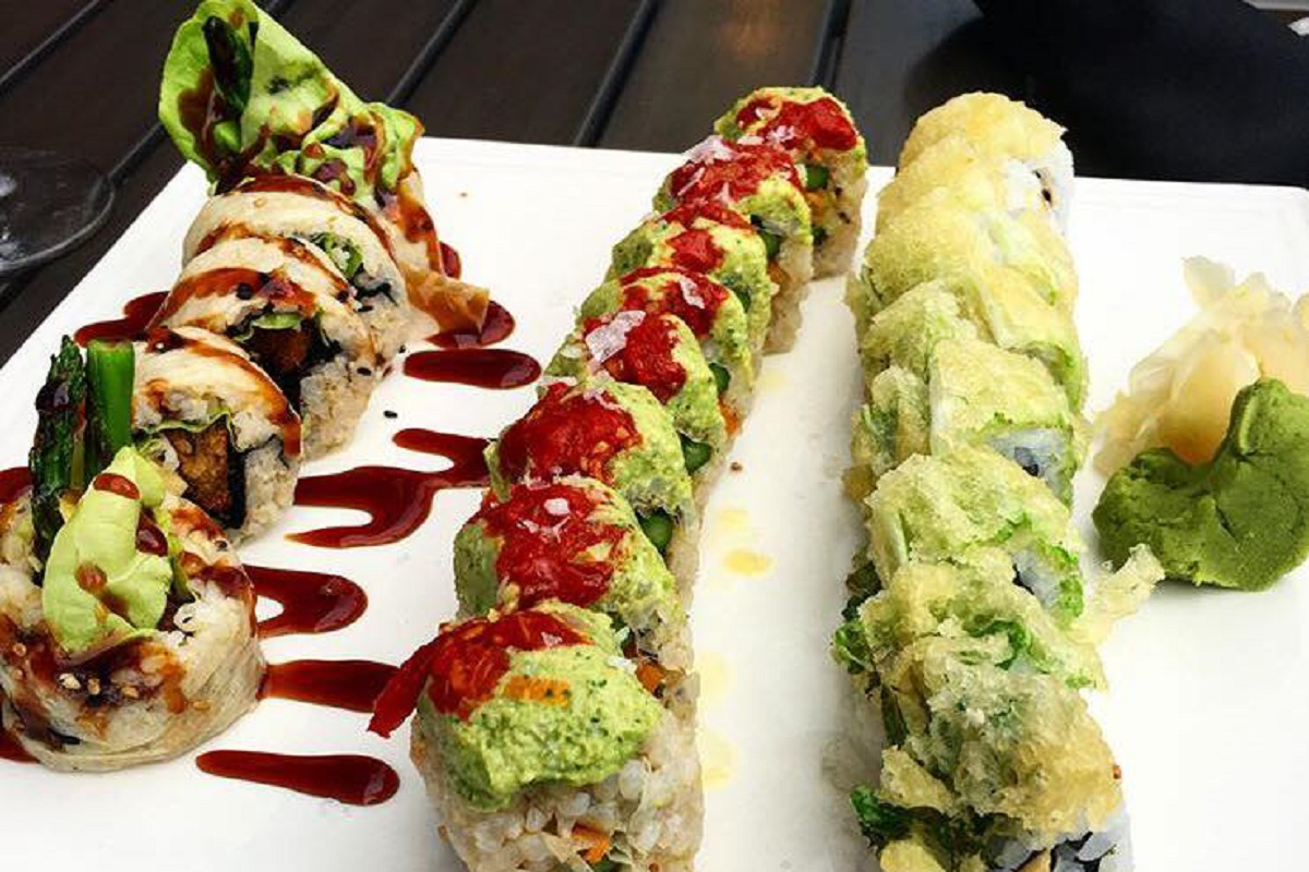 Shojin, Eden Roll, and Crunchy Cabbage vegan sushi rolls at Blue Sushi Sake Grill in LoDo Denver, topped with tempura, avocado, and sauces.