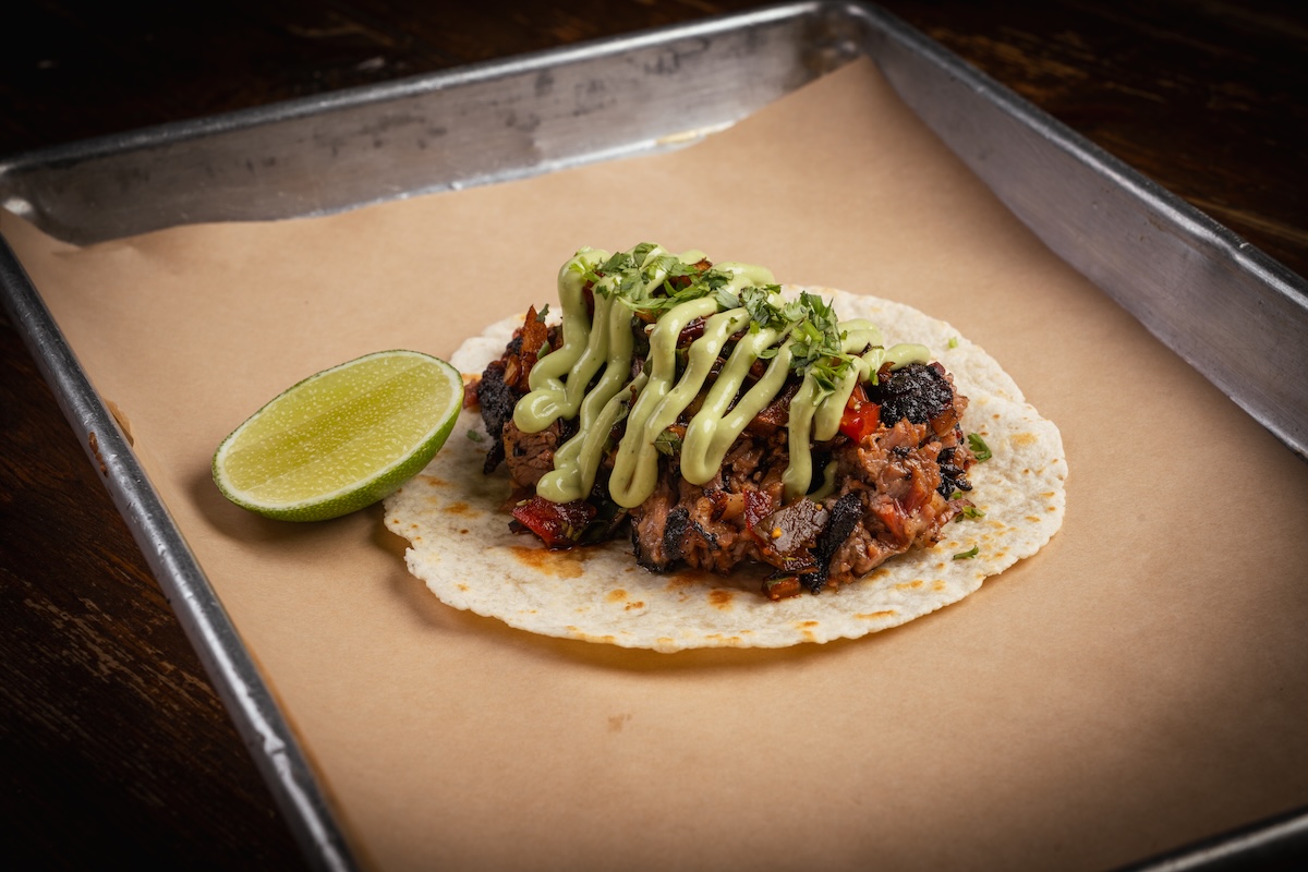 calzone - DiningOut The Brisket Taco is the perfect combination of Mexican and Texan barbecue. | Photo by Riot BBQ