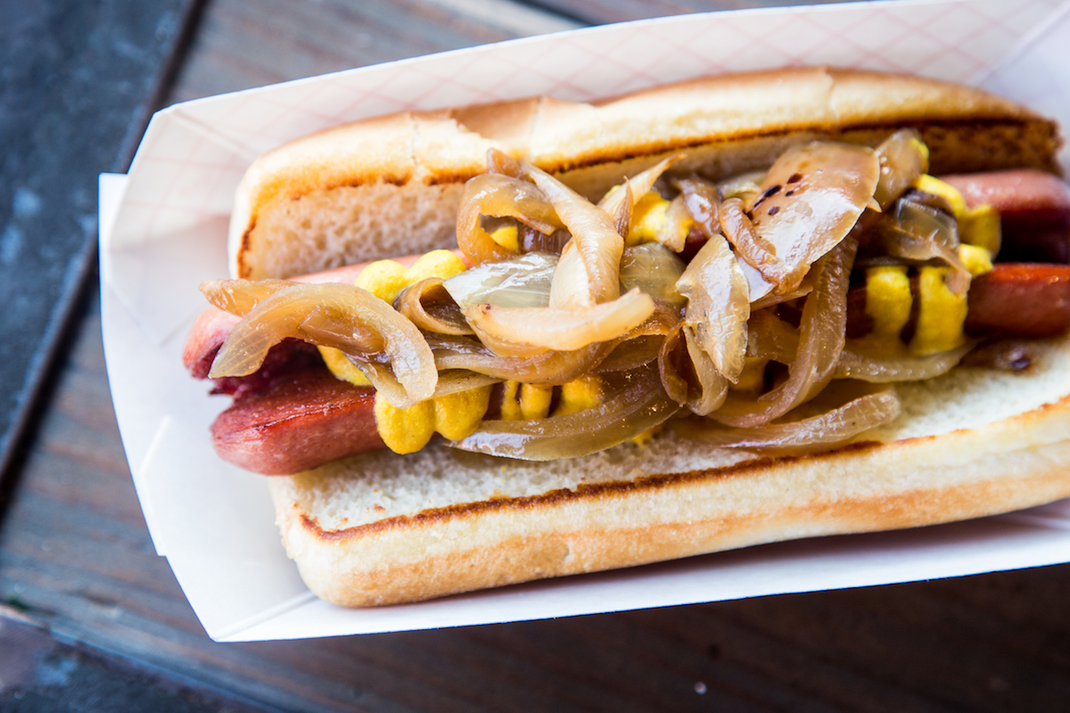 The vegetairan tofu dog,  topped with grilled onions and mustard at the Burger Joint. | Photo by Becca Wright