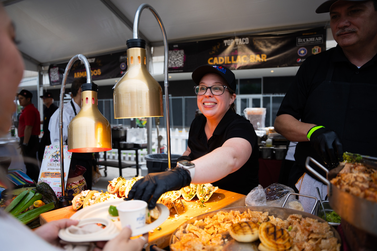 The Cadillac Bar staff hand out tacos at Top Taco. | Photo by DiningOut Events