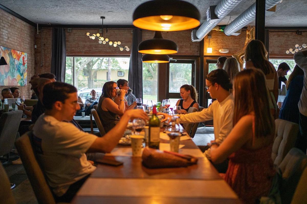 Camerata - DiningOut Customers raise a glass at Camerata, neighboring Paulie's in Montrose. | Photo by Camerata