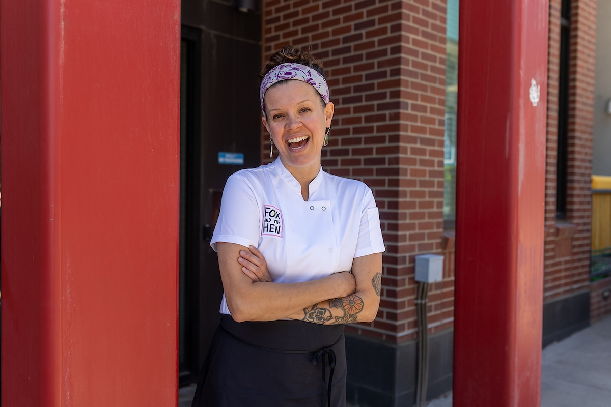 chef carrie baird in front of red door in denver