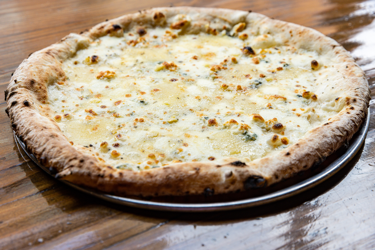 - DiningOut Global New York-style cheese pizza at Pizaro's. | Photo by Emily Jaschke