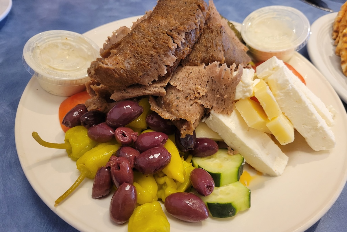 - DiningOut greek platter with gyro and olives and feta
