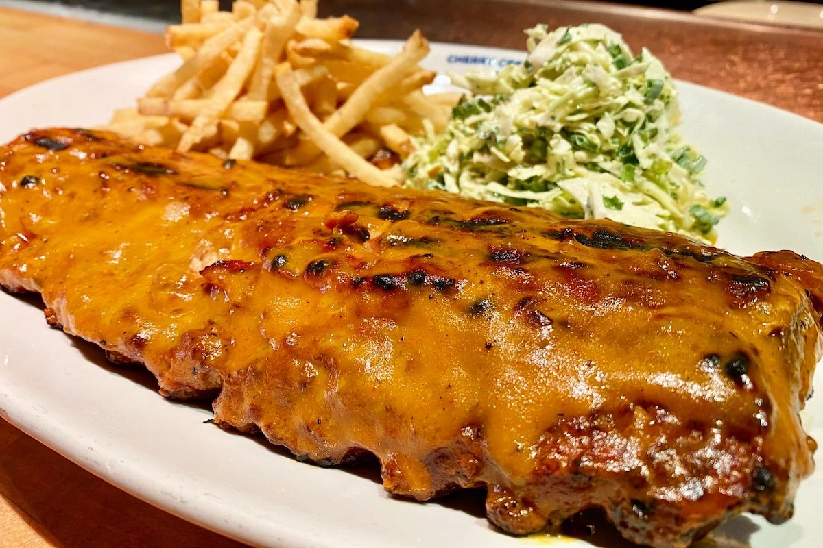 Barbecue ribs with golden glaze served with French fries and creamy slaw at Cherry Creek Grill in Denver.

