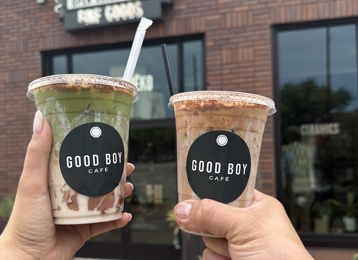 A coffee cheers outside Good Boy Cafe, located inside Hey Koneko. | Photo by Desiree Gutierrez