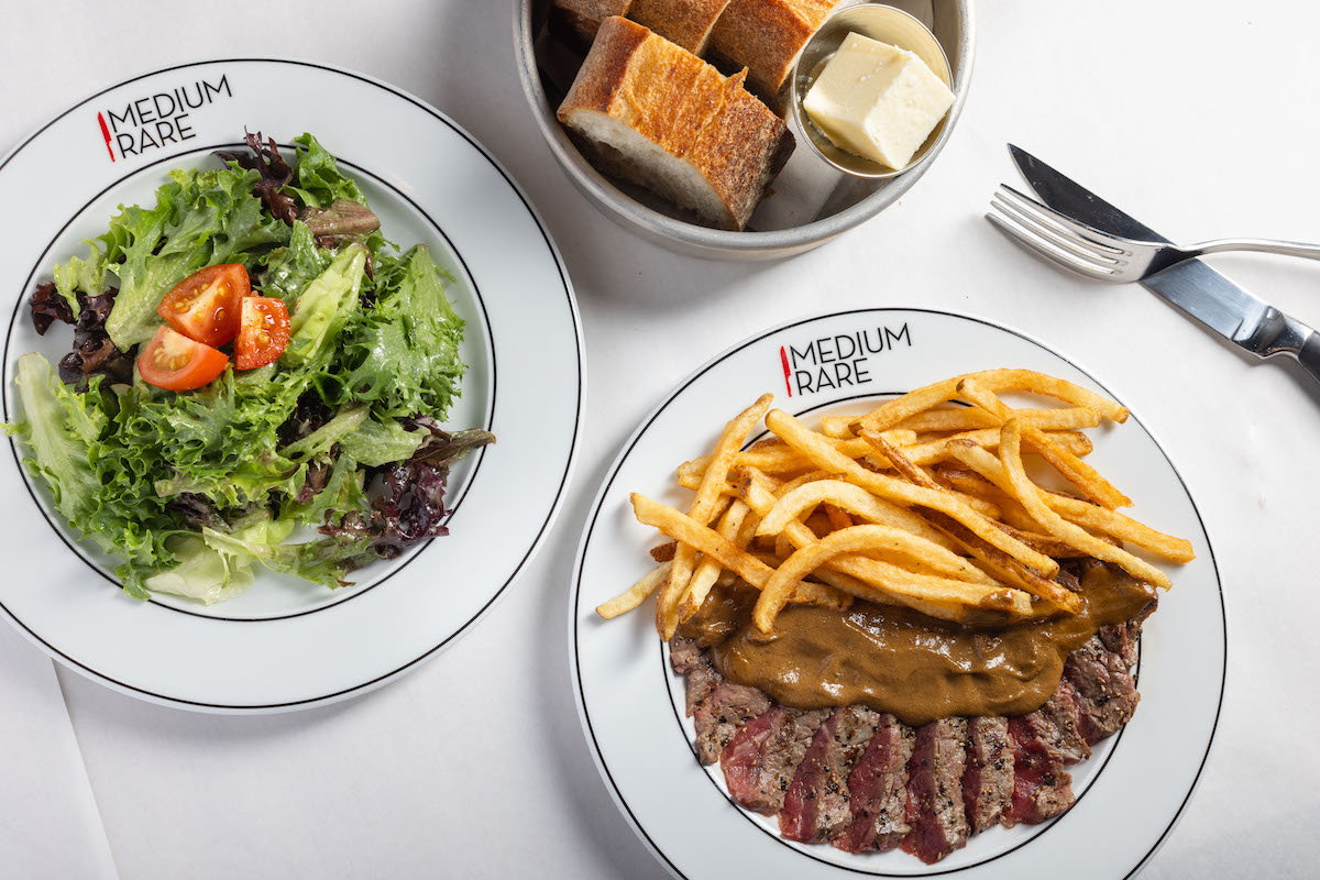 - DiningOut Steak with fries, mixed greens, and bread at Medium Rare. | Photo by Medium Rare