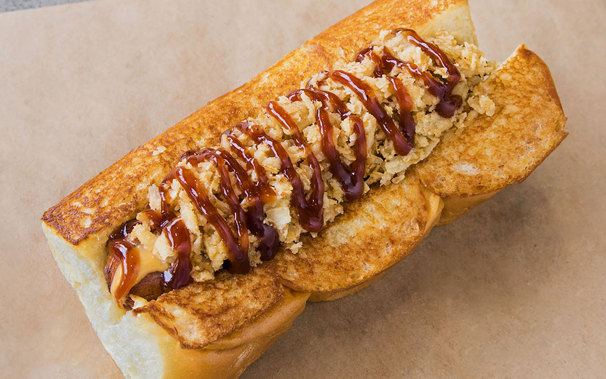 The Cowboy hot dog at Dog Haus, made with smoked bacon, crispy onions, and barbecue sauce. | Photo by Dog Haus