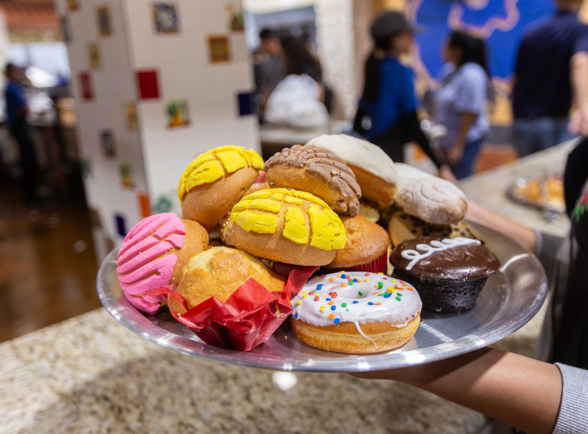 A stack of concha and pastries atop El Bolillo's famed pizza trays. | Photo by Andrew Hemingway