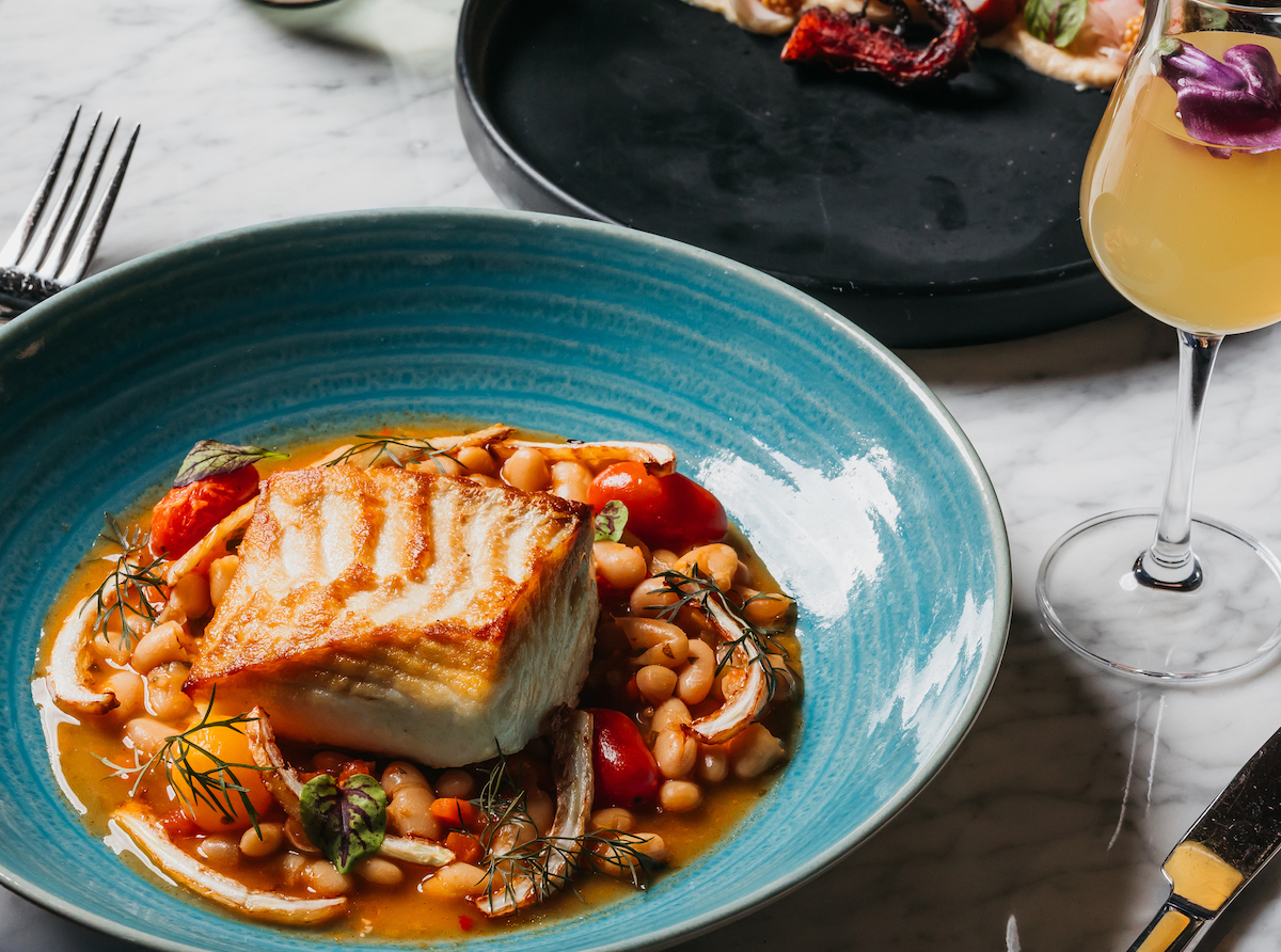 Seared halibut with stewed white beans, melted tomatoes, and charred fennel at Emilia's. | Photo by Thomas Welch