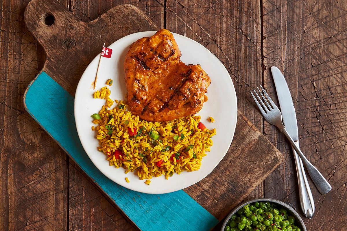 Flame-grilled butterfly chicken breast with Portuguese rice and macho peas at Nando's. | Photo by Greg Powers