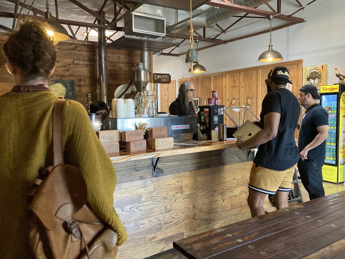 Customers await their orders at Full City Rooster Coffee Roasting Studio. | Photo by Full City Rooster Coffee Roasting Studio