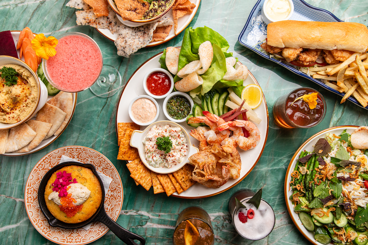A spread of dishes and drinks at Good God, Nadine's. | Photo by Becca Wright