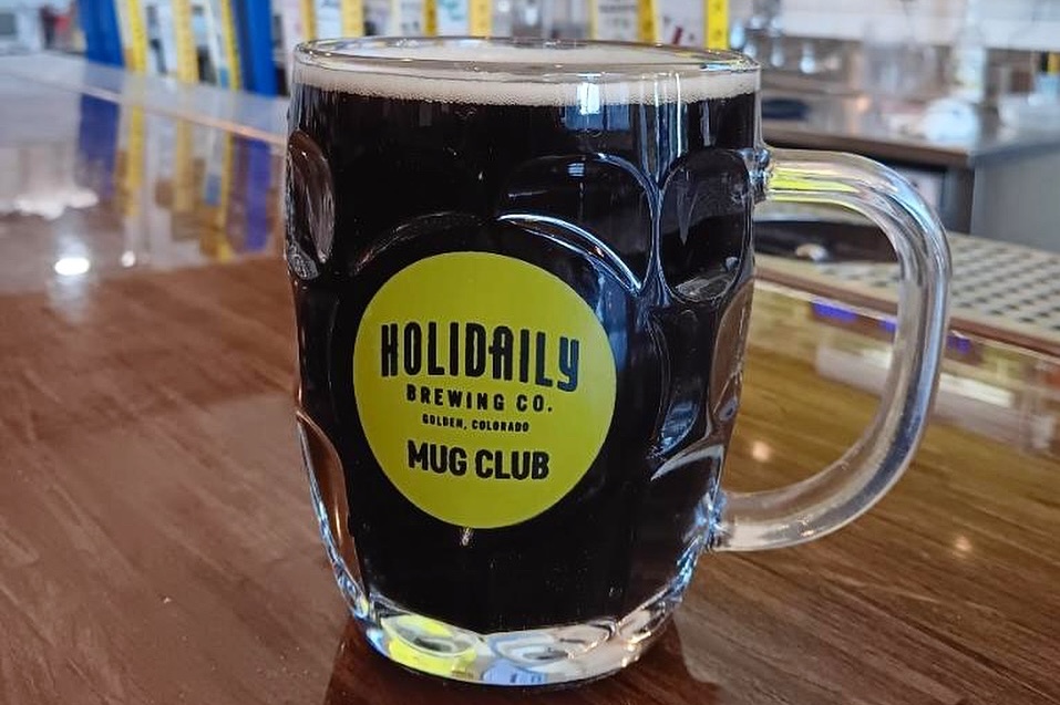 mug of dark stout beer on wood table