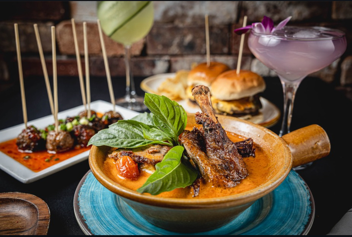 Red curry duck with other dishes and cocktails at Songkran Thai Kitchen. | Photo by Songkran Thai Kitchen