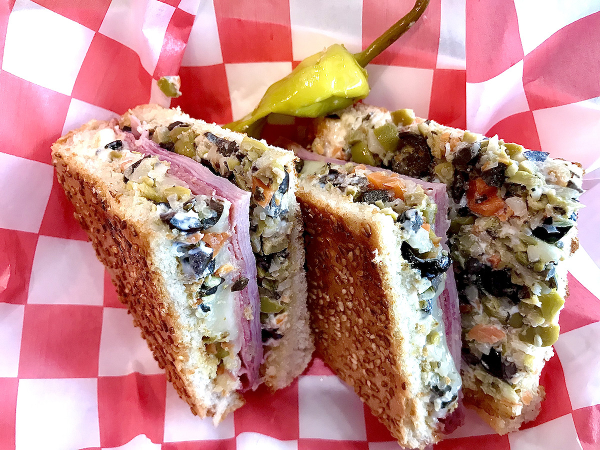 - DiningOut The muffuletta at Paulies Poboys. | Photo by Greg Morago
