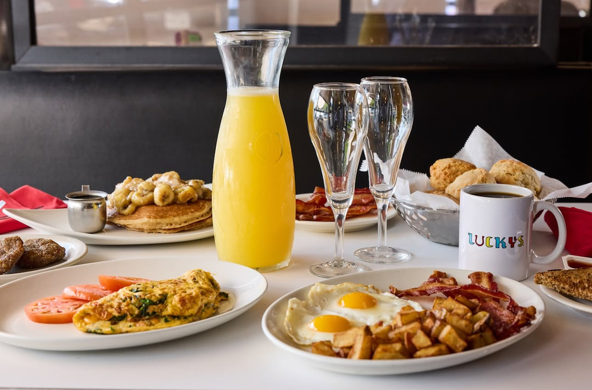 A breakfast spread with mimosas at Lucky's Cafe. | Photo by Lucky's Cafe