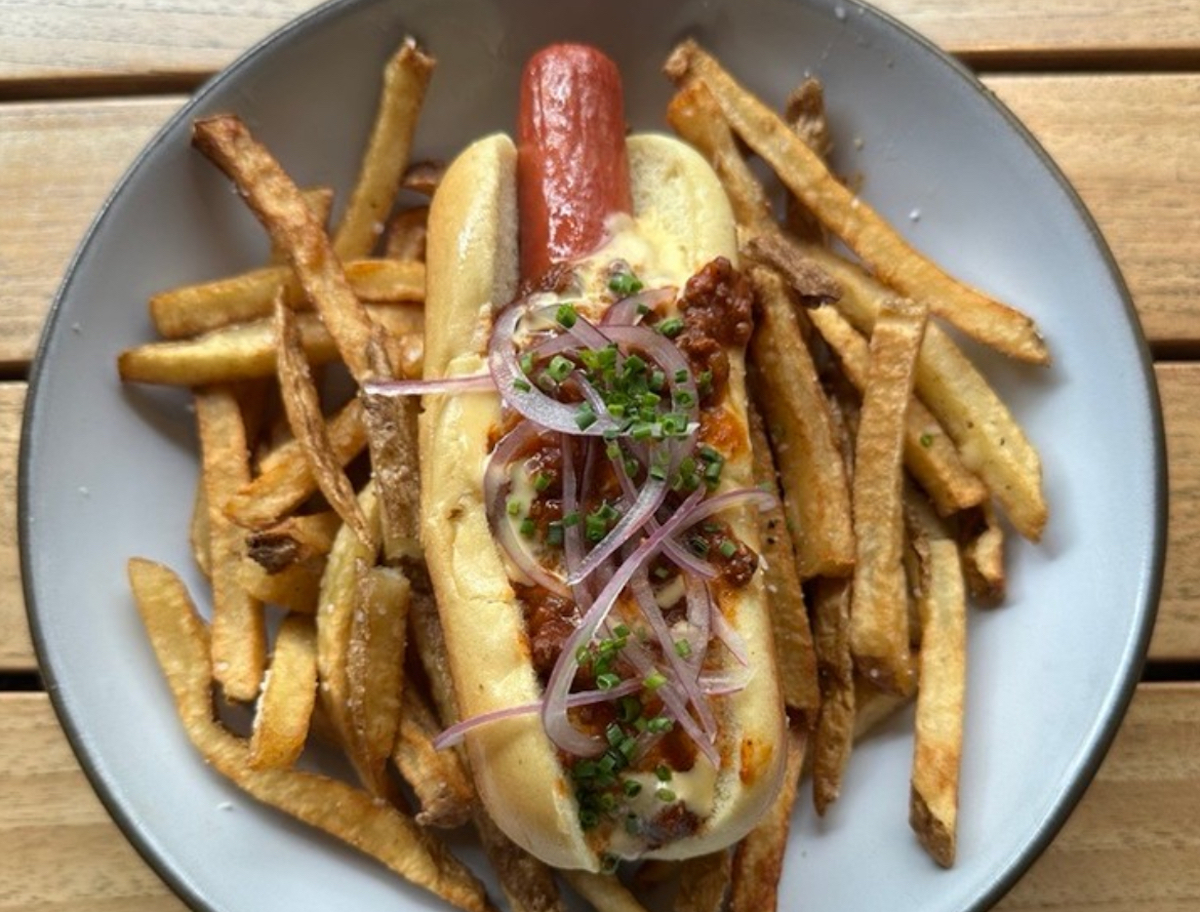 Wagyu beef hot dog and fries at Bayou & Bottle. | Four Seasons Houston