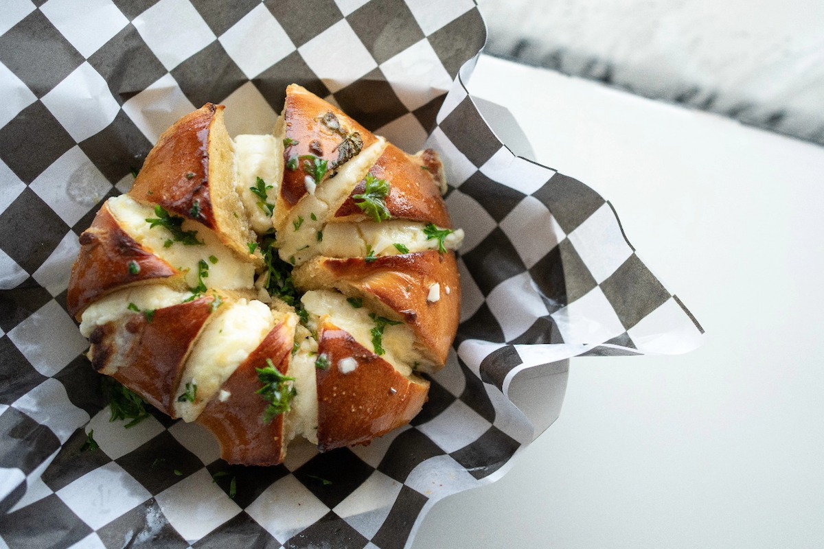 The Burrosa Bagel at Jersey Bagels, sliced and stuffed with garlic cream cheese. | Photo by Jersey Bagels