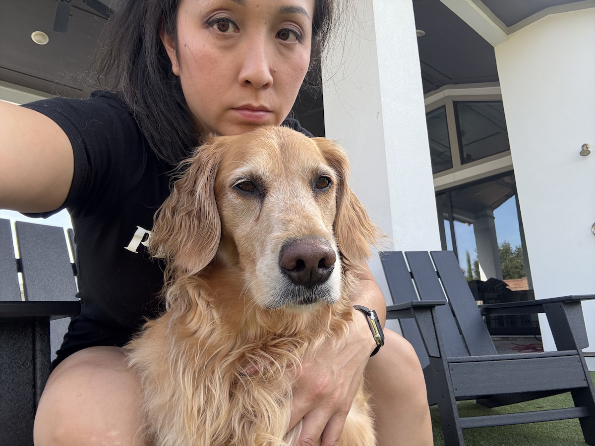 Julie Nguyen, co-owner of Crawfish Cafe, Ocean Palace, and Pho Prime with her golden retriever Milo. | Photo courtesy of Julie Nguyen