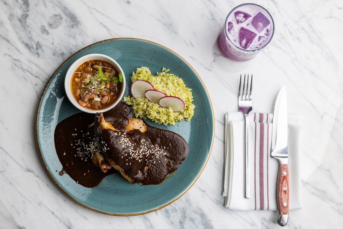 The roasted half chicken with a rich mole and green rice. | Photo by Kachina Cantina