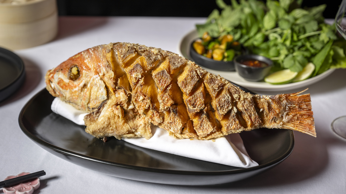Whole fried snapper at Le Pasage. | Photo by Evan Sung