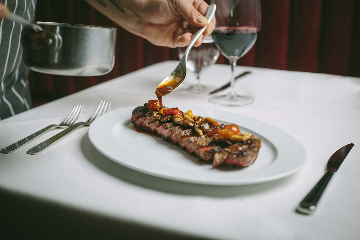 - DiningOut Finishing touches to a steak at Tango Room. | Photo by Tango Room