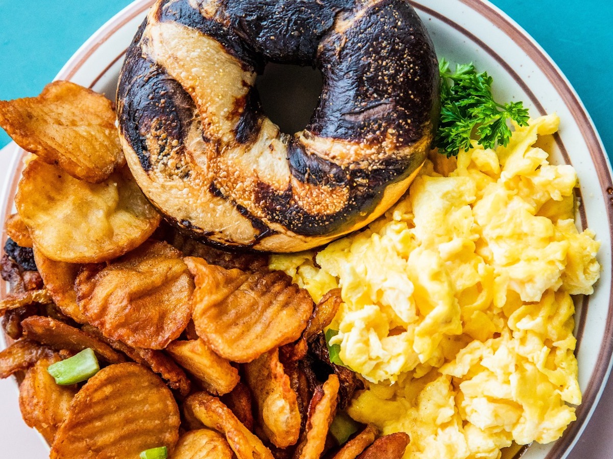 A bagel sandwich breakfast platter with scrambled eggs and home fries at New York Deli & Bagel Shop. | Photo by New York Deli & Bagel Shop
