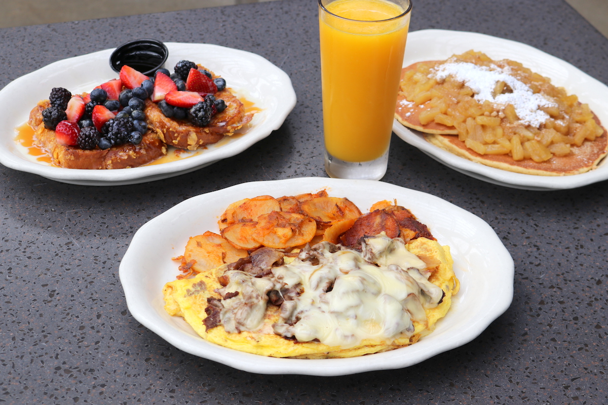 Philly cheesesteak omelet, caramel berry toast crunch, and pineapple rum pancakes at Kenny & Ziggy's. | Photo by Paula Murphy