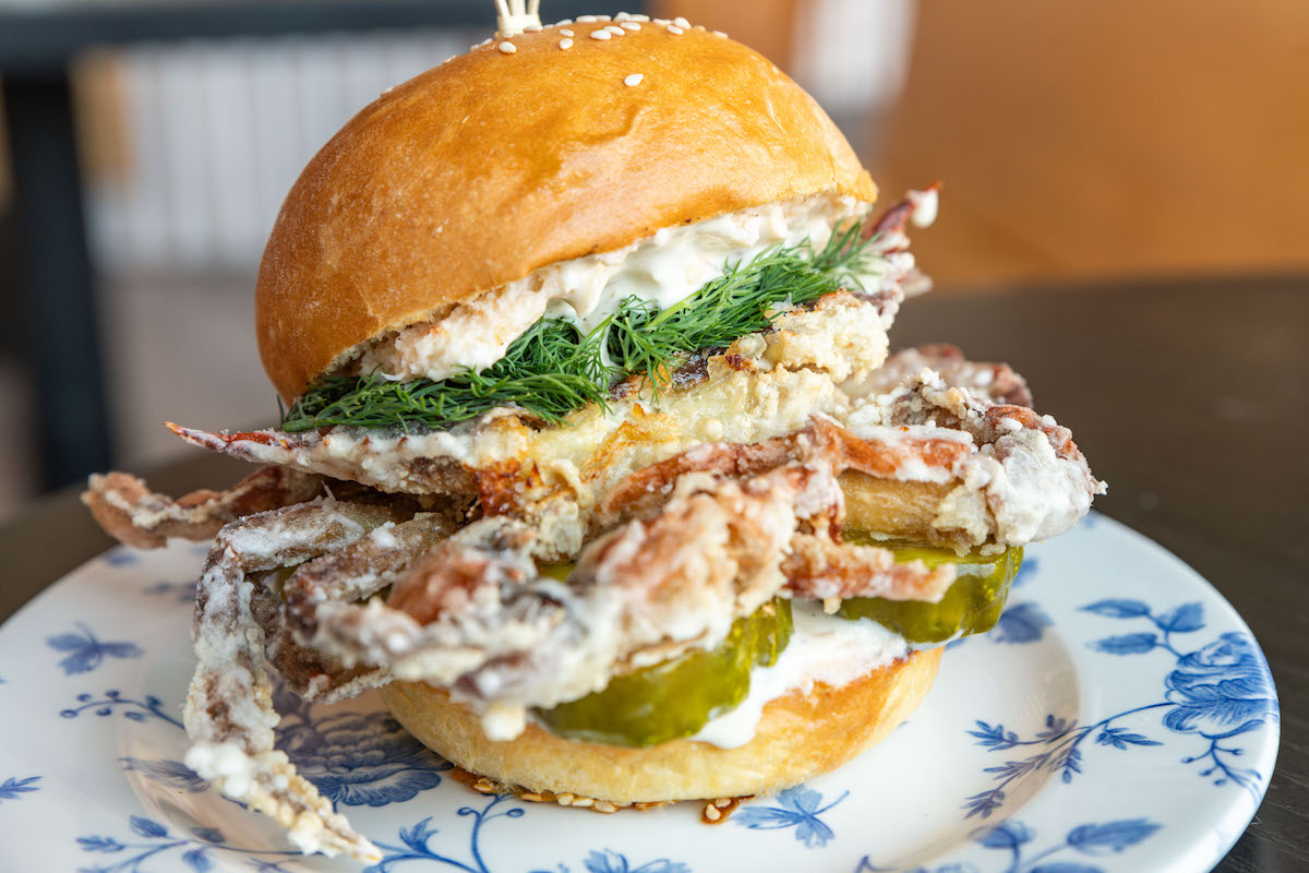 The soft shell crab banh mi, layered with pickles, shrimp pate, tartar sauce, and dill on a sesame milk bun at Pink Bellies. | Photo by Pink Bellies