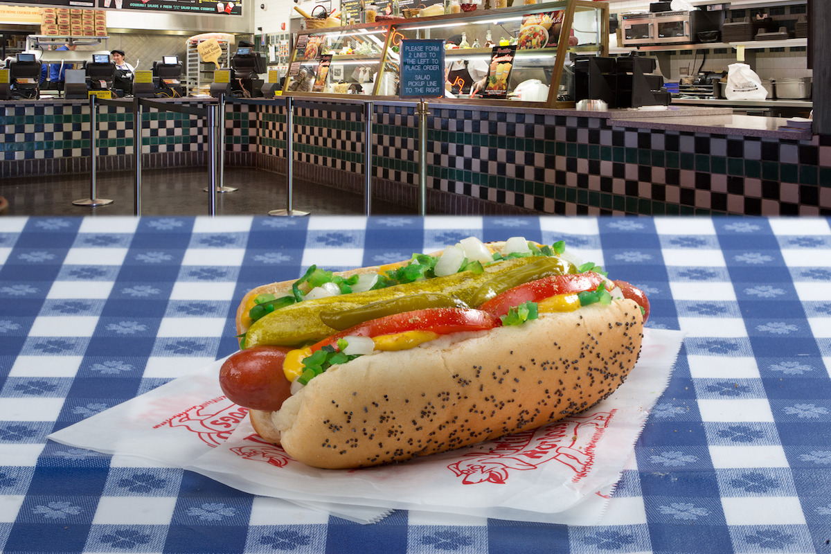 A Chicago-style hot dog, topped with lettuce, tomatoes, onions, and dill pickle spears at Portillo's | Photo by Portillo's