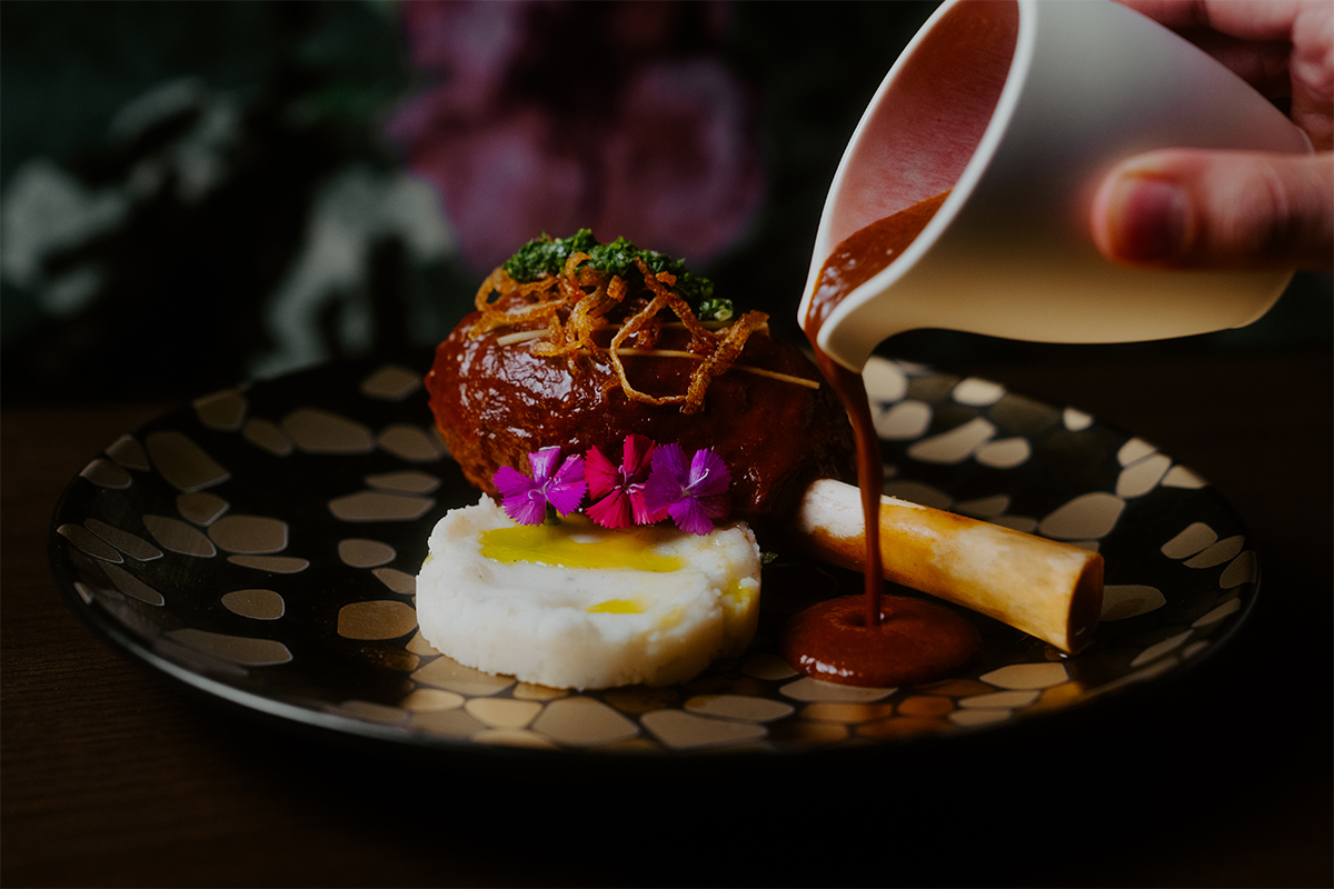 - DiningOut Red wine-braised lamb shank at Amrina. | Photo by Max Otter Productions