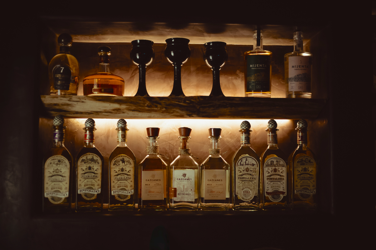 A backlit bar showcasing agave spirits at Bar Buena. | Photo by Goode Co.