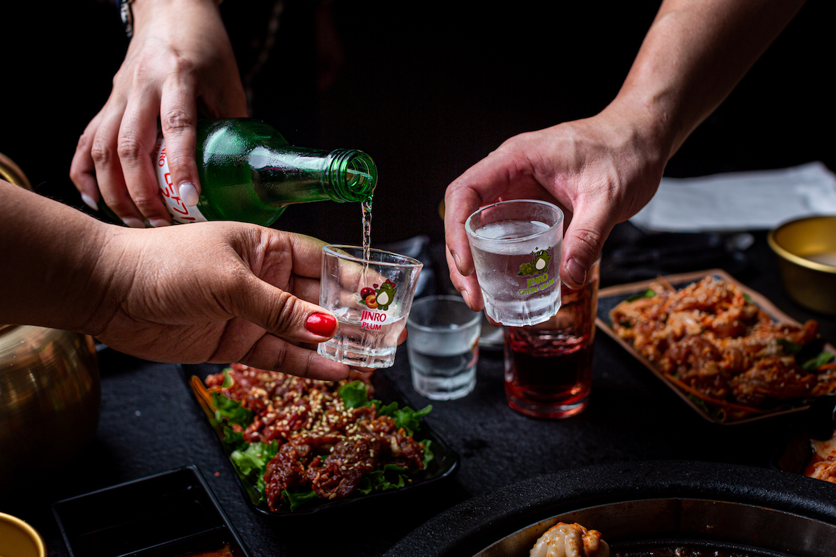 Guests pour soju at Hongdae 33. | Photo by Jenn Duncan