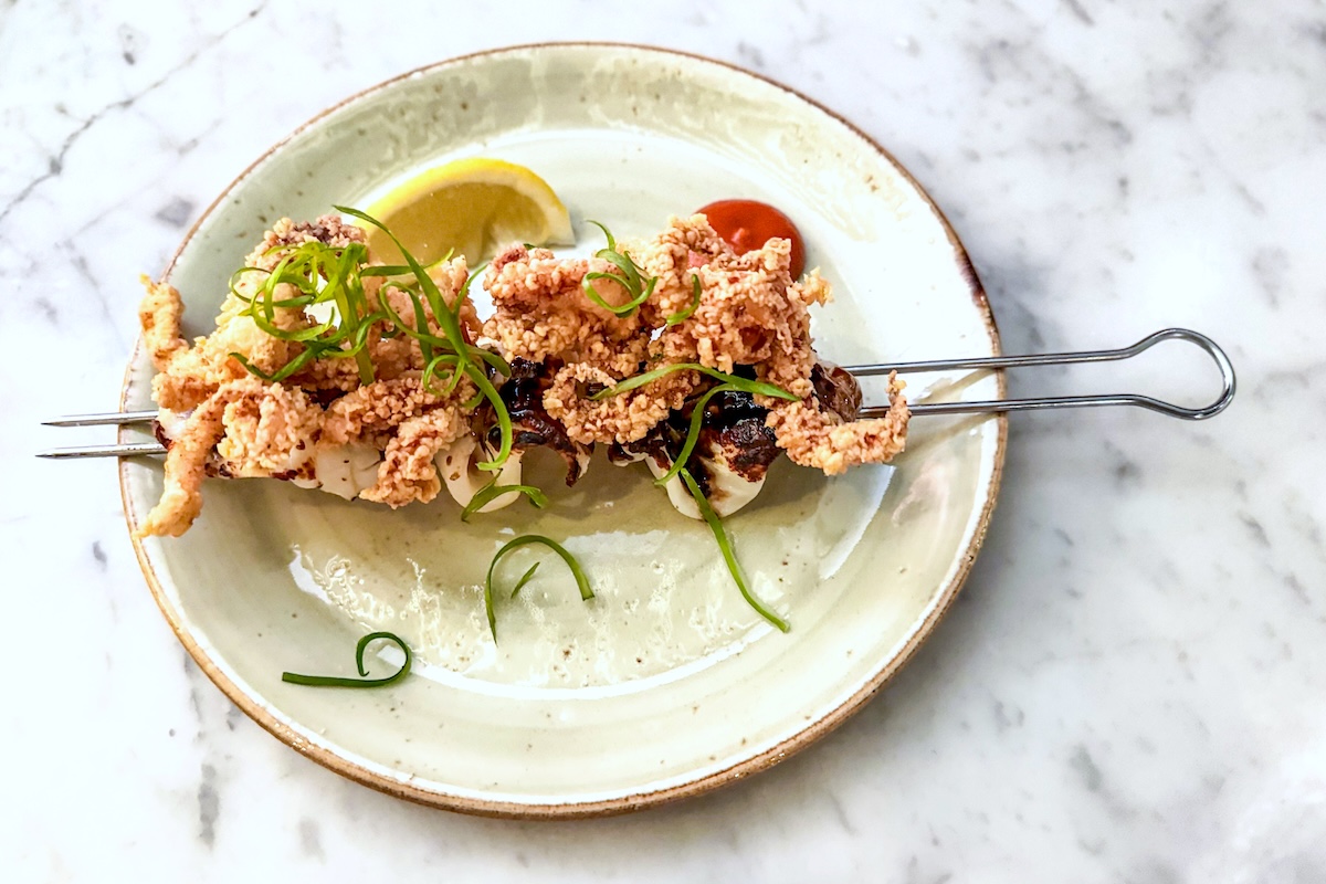 - DiningOut Squid is one of the many seafood plates served at Moëca. | Photo by Suzanne Podhaizer