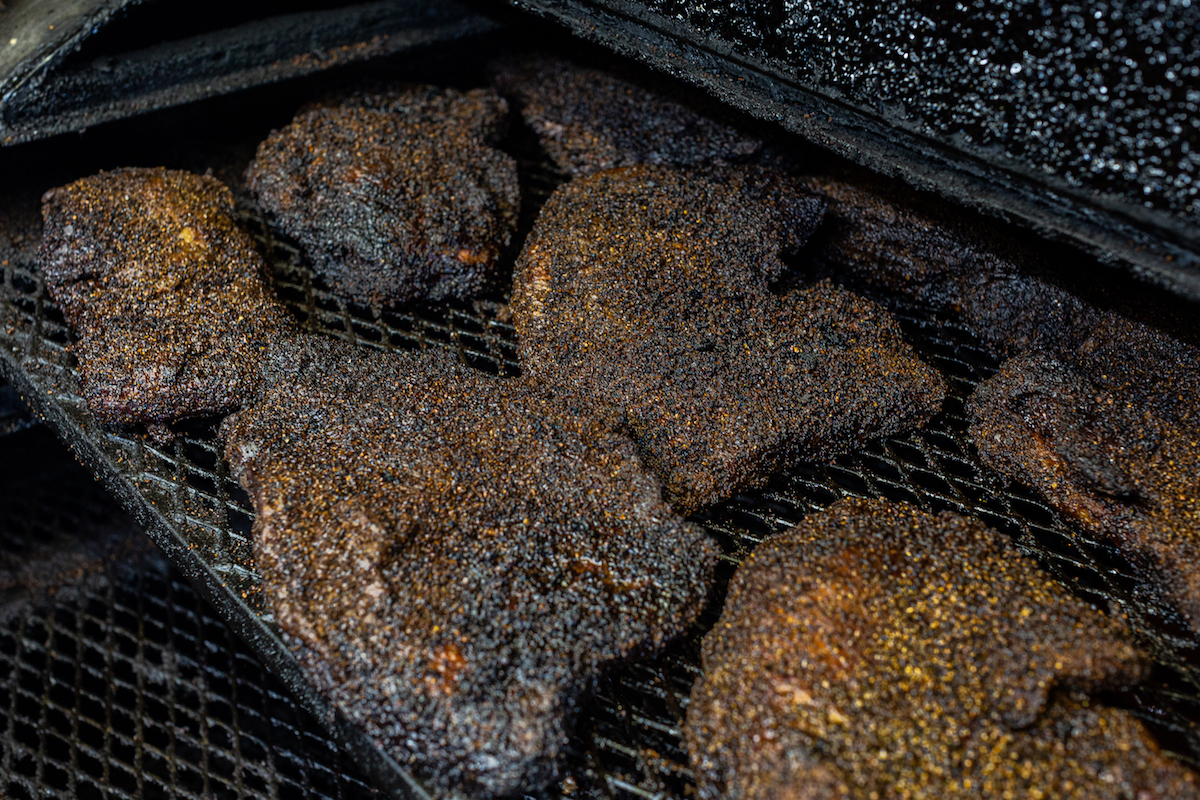 Briskets on the pit at the Pit Room. | Photo by Jenn Duncan