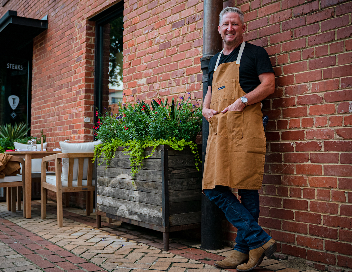Chef Tim Love poses in his Love collection canvas apron. | Photo by Daniel Hooks