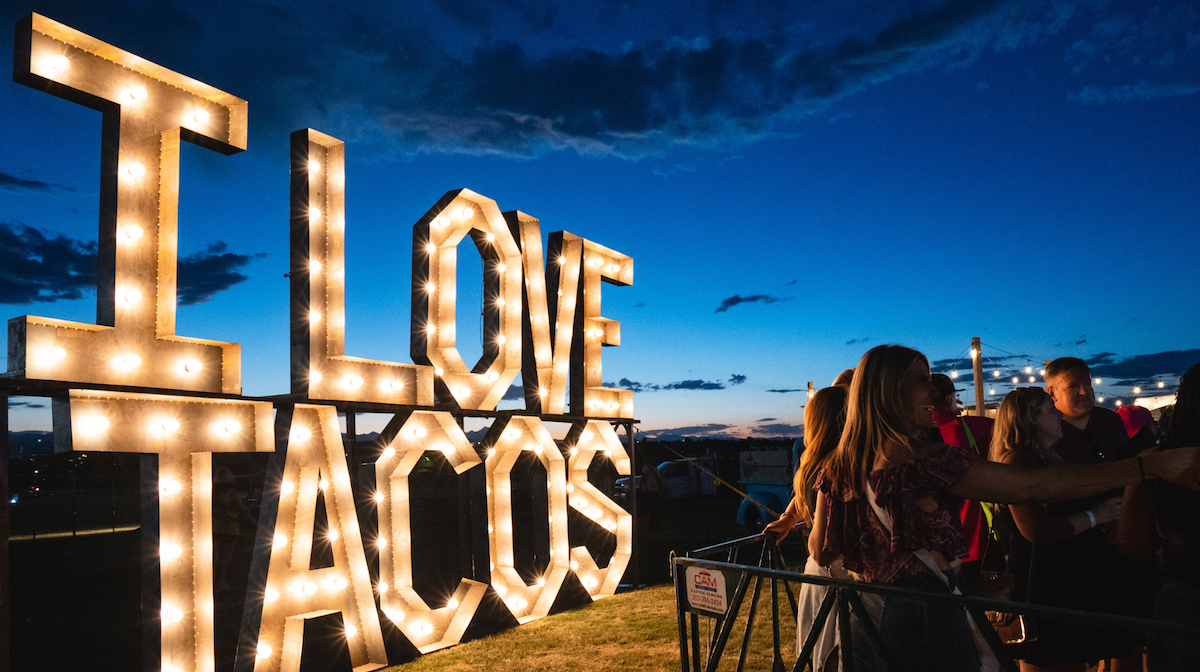 An "I Love Tacos" sign illuminates the night at Top Taco. | Photo by DiningOut Events