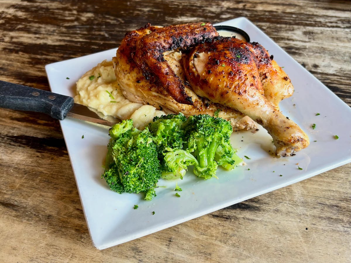A roasted half chicken served with mashed potatoes and broccoli at Vickery Park in Plano. | Photo by Vickery Park