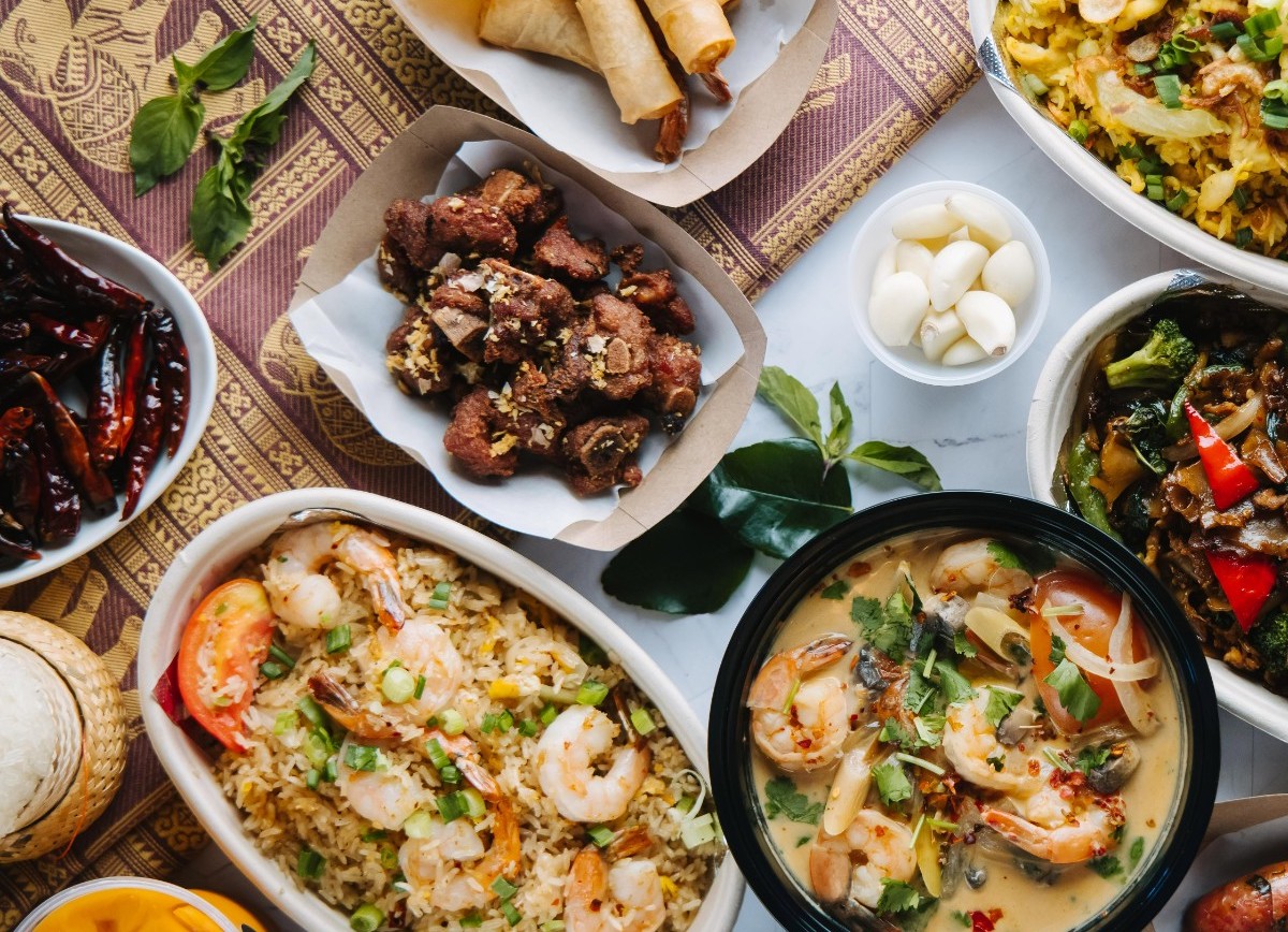 A tablescape with appetizers and entrees from Zaap Kitchen. | Photo by Zaap Kitchen