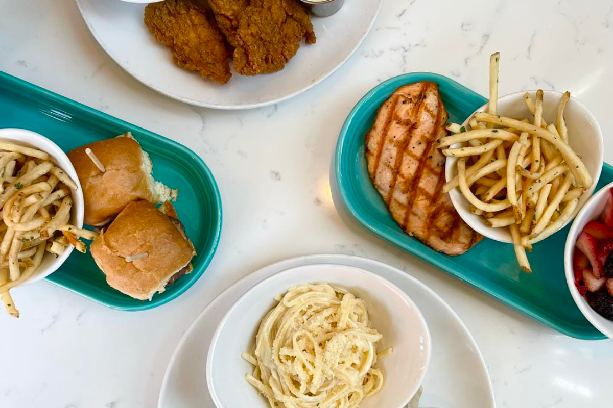 Kids meals with grilled salmon, pasta, sliders, fries, fruit, and chicken tenders at Blue Island Oyster Bar in Lone Tree near Denver.